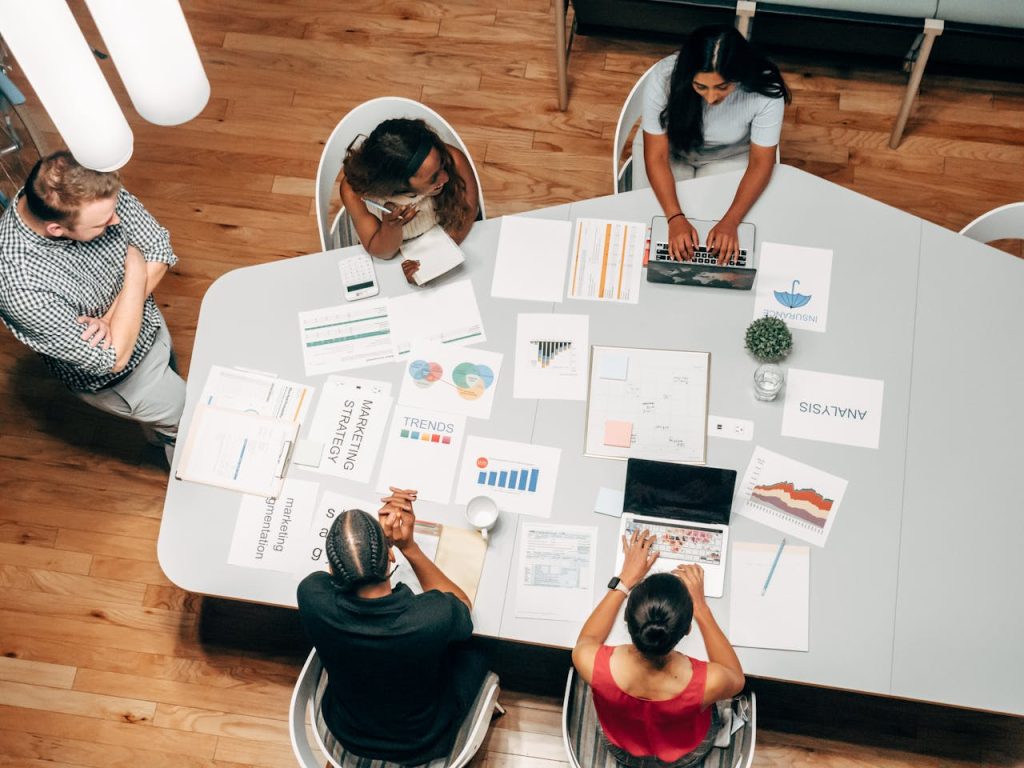 SEO-Tipps & EAT-Konzept: Das ultimative Domain Authority Webseitenverzeichnis A diverse group working on marketing strategies with charts and laptops in an office setting.SEO-Tipps & EAT-Konzept: Das ultimative Domain Authority Webseitenverzeichnis